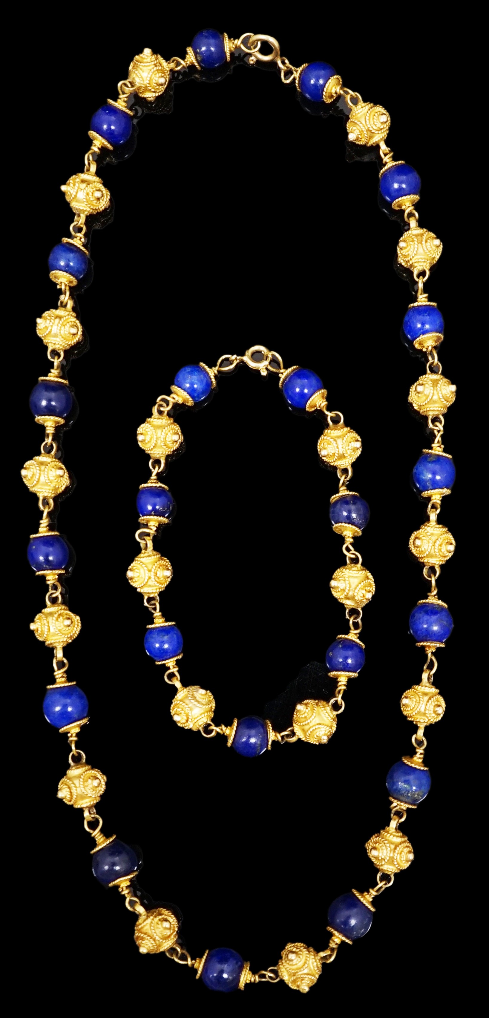 A 20th century Middle Eastern high carat gold canetile work bead and lapis lazuli bead set necklace and matching bracelet